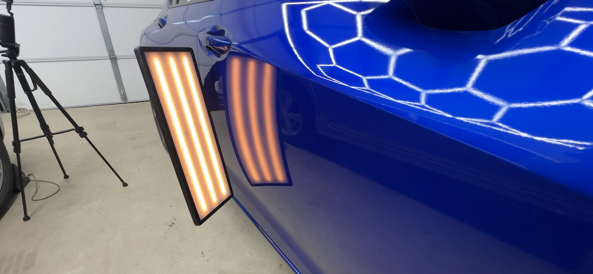 After paintless dent repair showing restored reflection lines and smooth panel finish