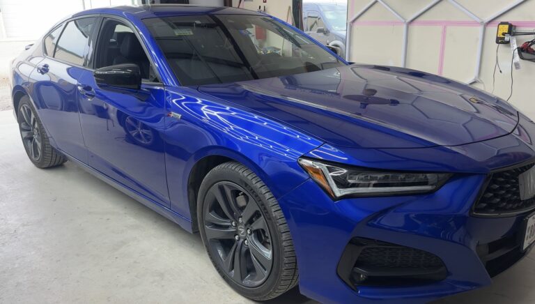 Paintless dent repair on blue sedan showing full vehicle condition before repair in Aubrey Tx.