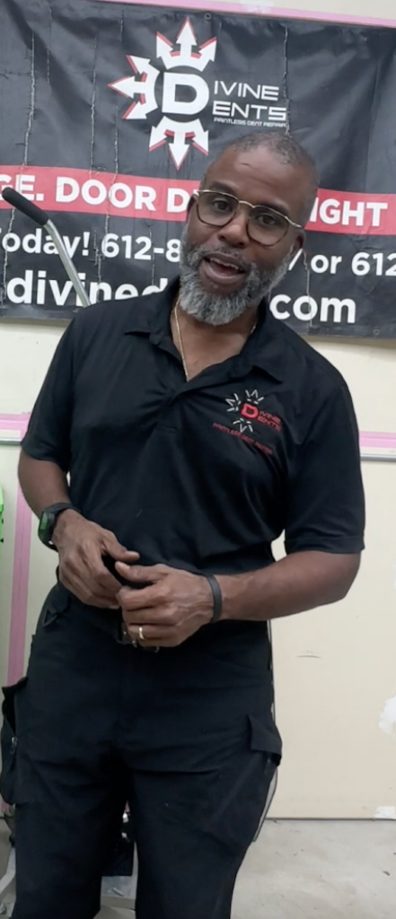 Paintless dent repair technician inspecting vehicle before purchase in Plano Texas