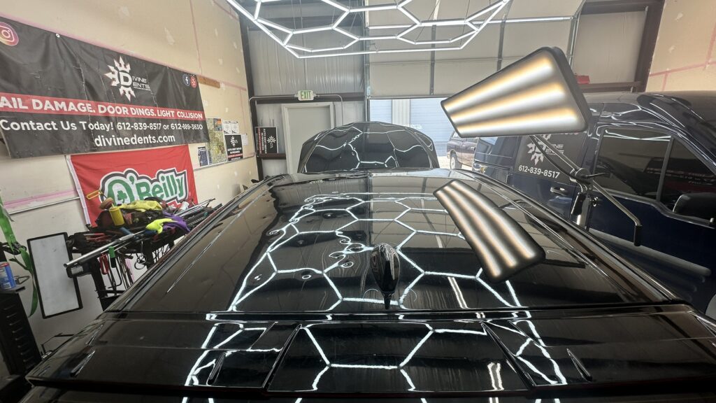Side-by-side comparison of a hail-damaged vehicle roof showing unrepaired damage on the left side and repaired roof section on the right side after Paintless Dent Repair.