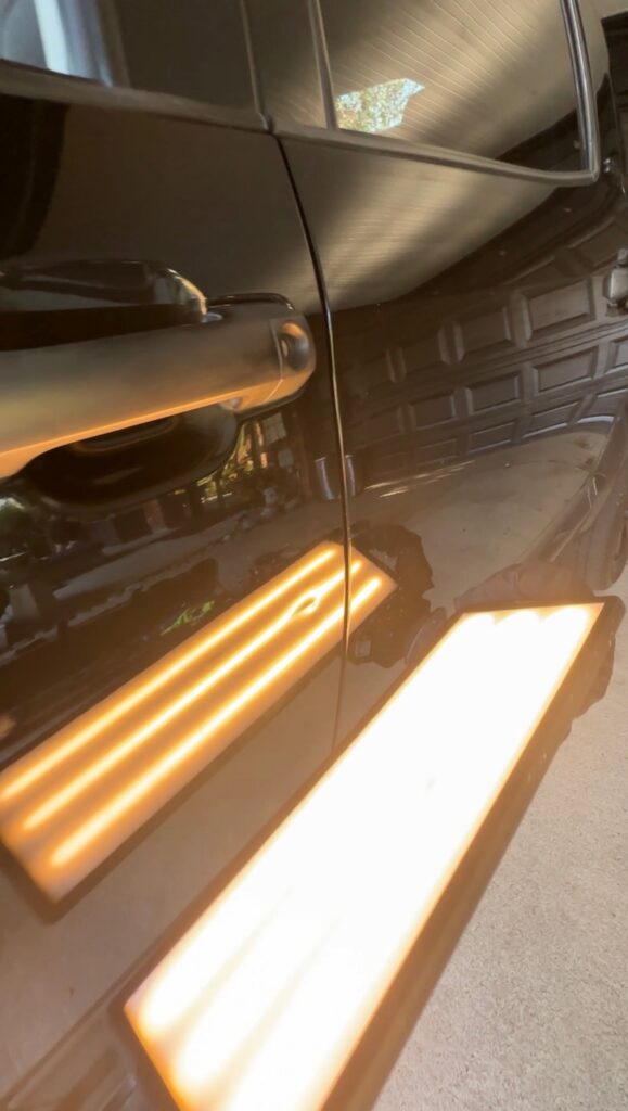 Warranty paintless dent repair on truck driver door using PDR reflection light in Aubrey TX